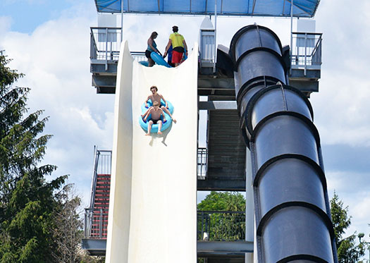 Boys going down a water slide